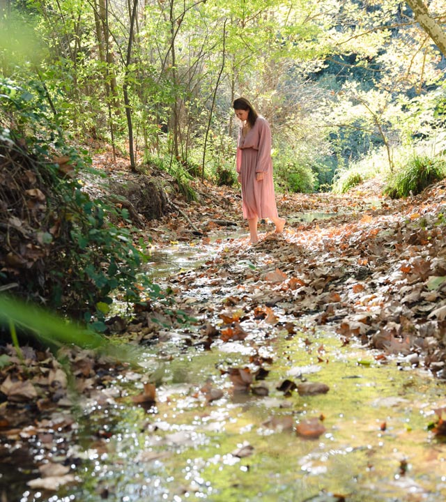 Portrait of Sylwia Kieszkowska walking in the forest.